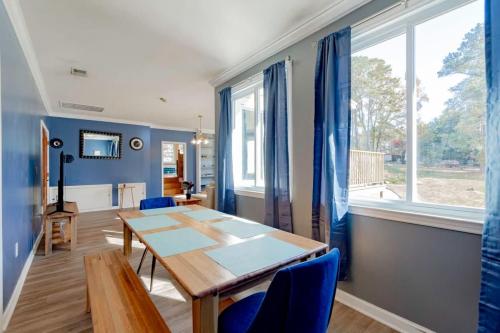 a dining room with a wooden table and blue chairs at Sweet Retreat-- Mins to Columbia in Columbia