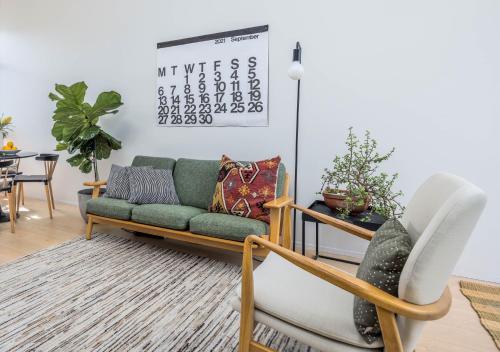 a living room with a couch and two chairs at Freemans Bay Botanical Loft - Walk to Ponsonby & Waterfront in Auckland