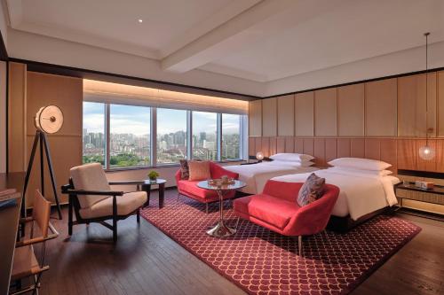 a hotel room with a bed and a large window at Hyatt Centric Zhongshan Park Shanghai in Shanghai