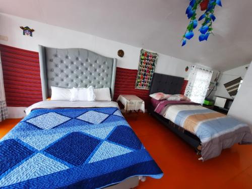 a bedroom with two beds in a room at Uros Titicaca UMA lodge in Puno