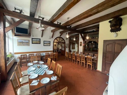 a dining room with wooden tables and chairs at Penzion U Šlechtů in Sněžné