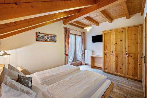 a bedroom with a bed and a tv in a room at Stoffnerhof Apt Edelweiß in Tesido
