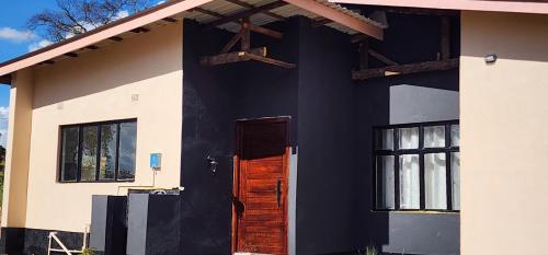 a black and white house with a door at Aima Villas in Chanamo