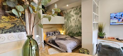 a bedroom with a bed in a room with a vase at Adam & Eve in Paladru