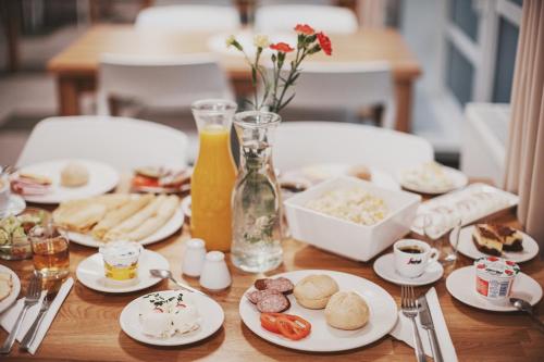 a wooden table with plates of food on it at Hotel Jaworzyna Krynicka in Krynica Zdrój
