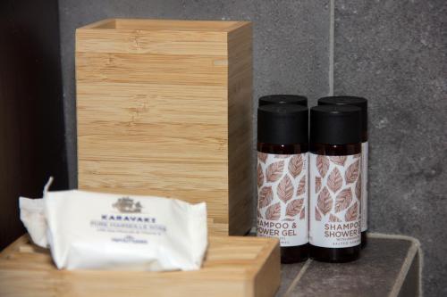 two bottles of spices sitting next to a wooden box at Lithorama Residence Mani - Second Floor in Koúmani
