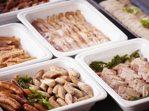 four styrofoam containers filled with different types of food at Hotel Amsterdam Huis Ten Bosch in Sasebo