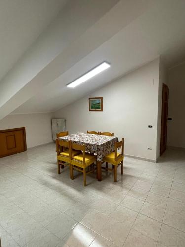 ein Esszimmer mit einem Tisch und 4 Stühlen in der Unterkunft Mansarda a Foiano in Foiano di Val Fortore
