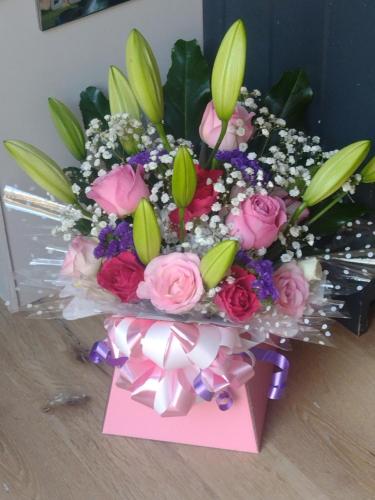 a bouquet of flowers in a box with a note at Sheep Dip Cottage - 5* Cyfie Farm, with log burner and private hot tub in Llanfyllin