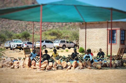 un grupo de niños sentados sobre un montón de animales en Valor Wellness Retreat en Windhoek