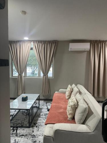 a living room with a couch and a table at 1st Living Subang SS15 in Subang Jaya
