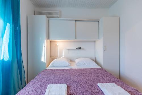 a bedroom with a bed with two towels on it at Tinka, Zimmer No 6 in Starigrad-Paklenica
