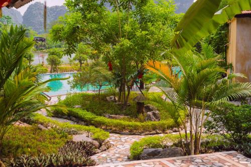 a resort with a swimming pool and a garden at Trang An Hometown Homestay in Ninh Binh