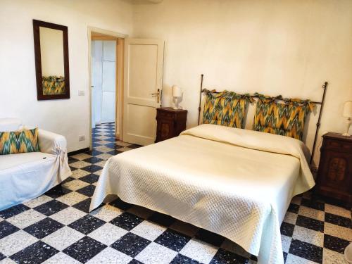 a bedroom with a bed and a checkered floor at Borgo La Torre alle Tolfe in Siena
