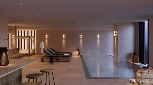a lobby with a couch and chairs and a pool at Clarion Hotel Karlatornet in Gothenburg