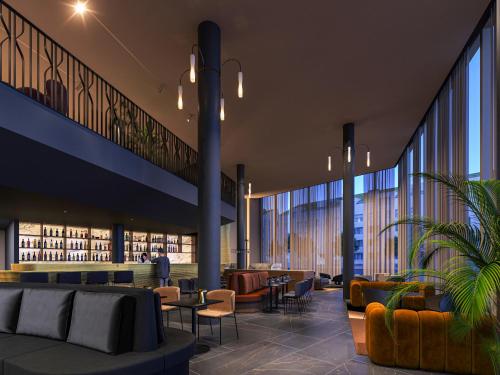 a library with couches and tables and chairs at Clarion Hotel Karlatornet in Gothenburg