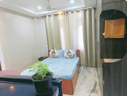 a small bedroom with a bed and a window at Riverside Palm 1BHK with AC and Terrace Access near Kamakhya temple in Guwahati