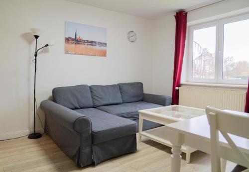 a living room with a couch and a table at Schleiblick App 6 in Rabenkirchen-Faulück