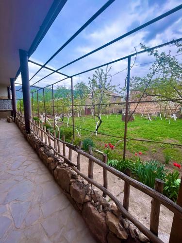 a fence with a view of a garden at HamEl Guest House in Odzun