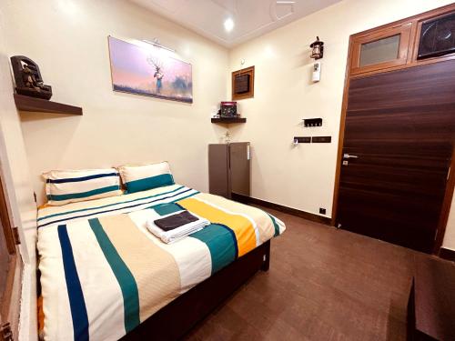 a bedroom with a bed and a door at Sumptuous 1BHk Couple friendly in Lucknow