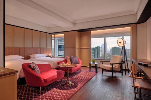 a hotel room with a bed and a large window at Hyatt Centric Zhongshan Park Shanghai in Shanghai