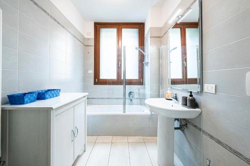 a white bathroom with a sink and a bath tub at "Once Upon A Time" Cherubini Palace Thematic Apartments Free Parking in Florence