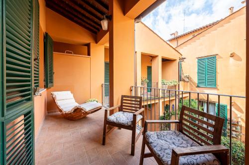 a patio with two chairs and a balcony at "Once Upon A Time" Cherubini Palace Thematic Apartments Free Parking in Florence