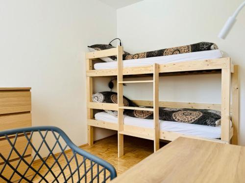 a room with a bunk bed and a staircase at ParkSide by BestChoice - Self Check-in with Parking Option in Graz
