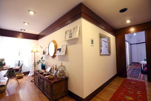 a living room with a large wall with a table at Tata B&B in Rome