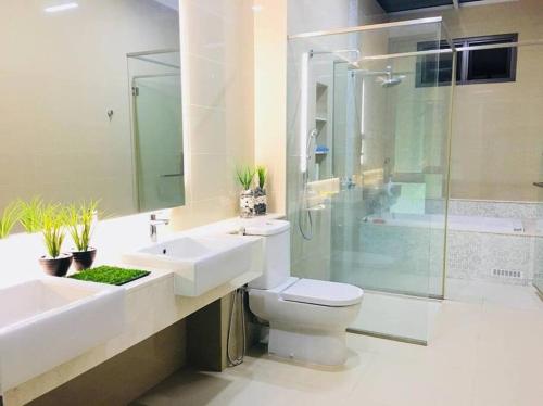a bathroom with a sink and a toilet and a shower at 5BR 3Storey Cozy Gelugor Homestay 15pax in Gelugor