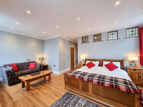 a bedroom with a bed and a couch at Min y Don Llandudno in Llandudno
