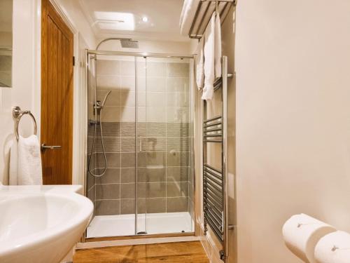 a bathroom with a shower and a sink at Min y Don Llandudno in Llandudno