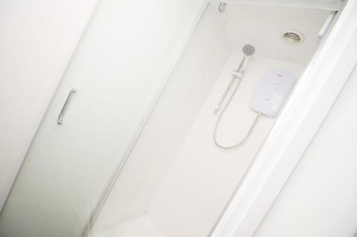 a shower in a bathroom with a shower curtain at Rugby Place by Tŷ SA in Newport