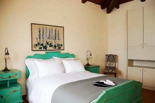 a bedroom with a bed with a green head board at Hillside Villa over Lemonodasos in Galatas