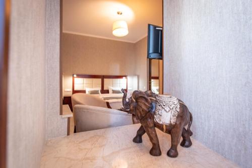 a wooden horse statue sitting on a table in a room at Kraveli Hotel in Tbilisi City