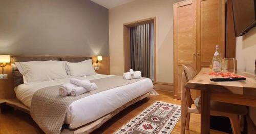 a hotel room with a bed with towels on it at Velar Hotel Boutique in Korçë
