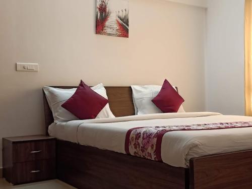 um quarto com uma cama grande com almofadas roxas e brancas em BNB Room em Nainital