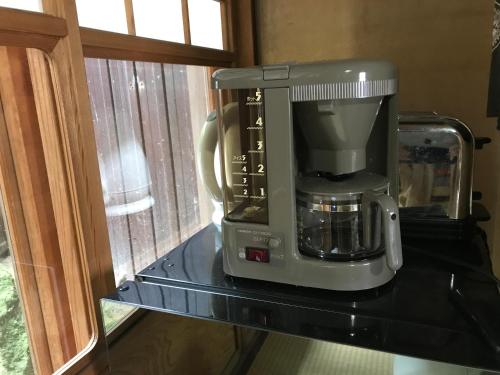 a coffee maker on a shelf in a kitchen at 金文堂 kinbundo in Himi
