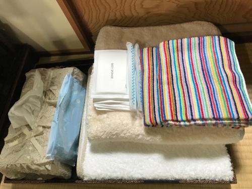 a pile of towels and a book in a drawer at 金文堂 kinbundo in Himi