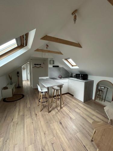 une cuisine avec une table et des chaises dans une pièce dans l'établissement Appartement Cosy à Tours - Parc EXPO, à Tours