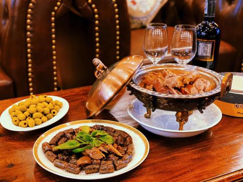a table with plates of food and glasses of wine at Mango room2 in Xóm Chua Thanh