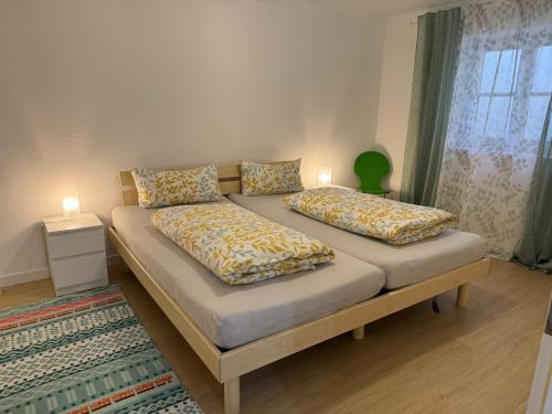 a bed with two pillows on it in a room at Ferienwohnung Kity mit Terrasse und Bergblick in Grainau
