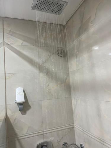 a shower with water hanging from the ceiling at Manarat Gaza Hotel - Al Haram Tower in Makkah