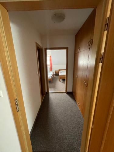 a hallway leading to a room with a bedroom at Penzion U Šlechtů in Sněžné