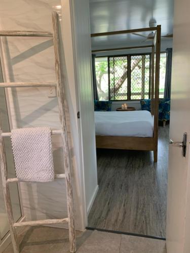 a bedroom with a bunk bed and a mirror at Turtle Cove Lake Front Cabin 300m To Beach in Hervey Bay