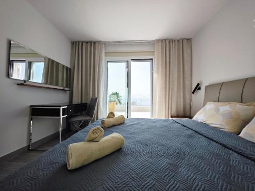 a bedroom with a large bed with two towels on it at Villa Sunrise first line in Coral Bay in Coral Bay