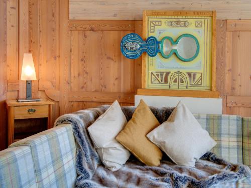 a couch with pillows on it in a room at Backstage Hotel Serviced Apartments in Zermatt