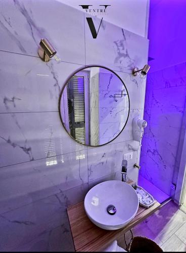 a bathroom with a sink and a mirror at Ventre luxury rooms in Naples