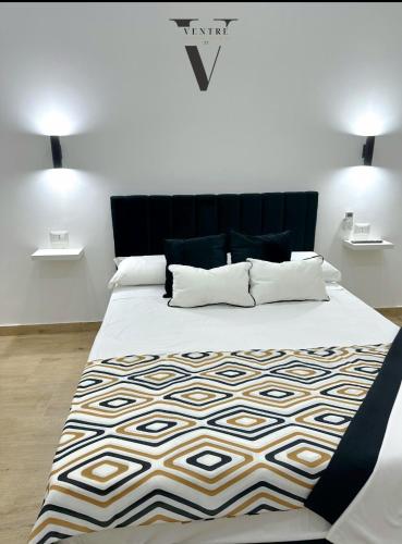 a bedroom with a large bed with a black headboard at Ventre luxury rooms in Naples