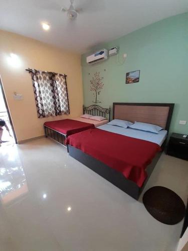 a bedroom with two beds and a television in it at OYO Flagship Relax Stay in Verem